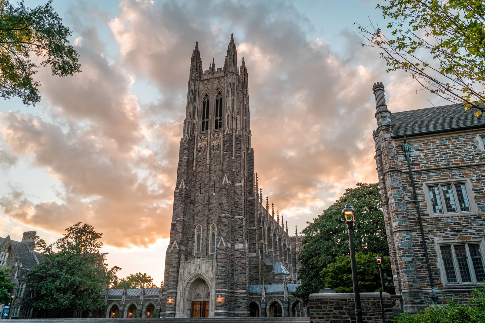 Duke Chapel glowing at sunset under golden clouds in Durham, North Carolina